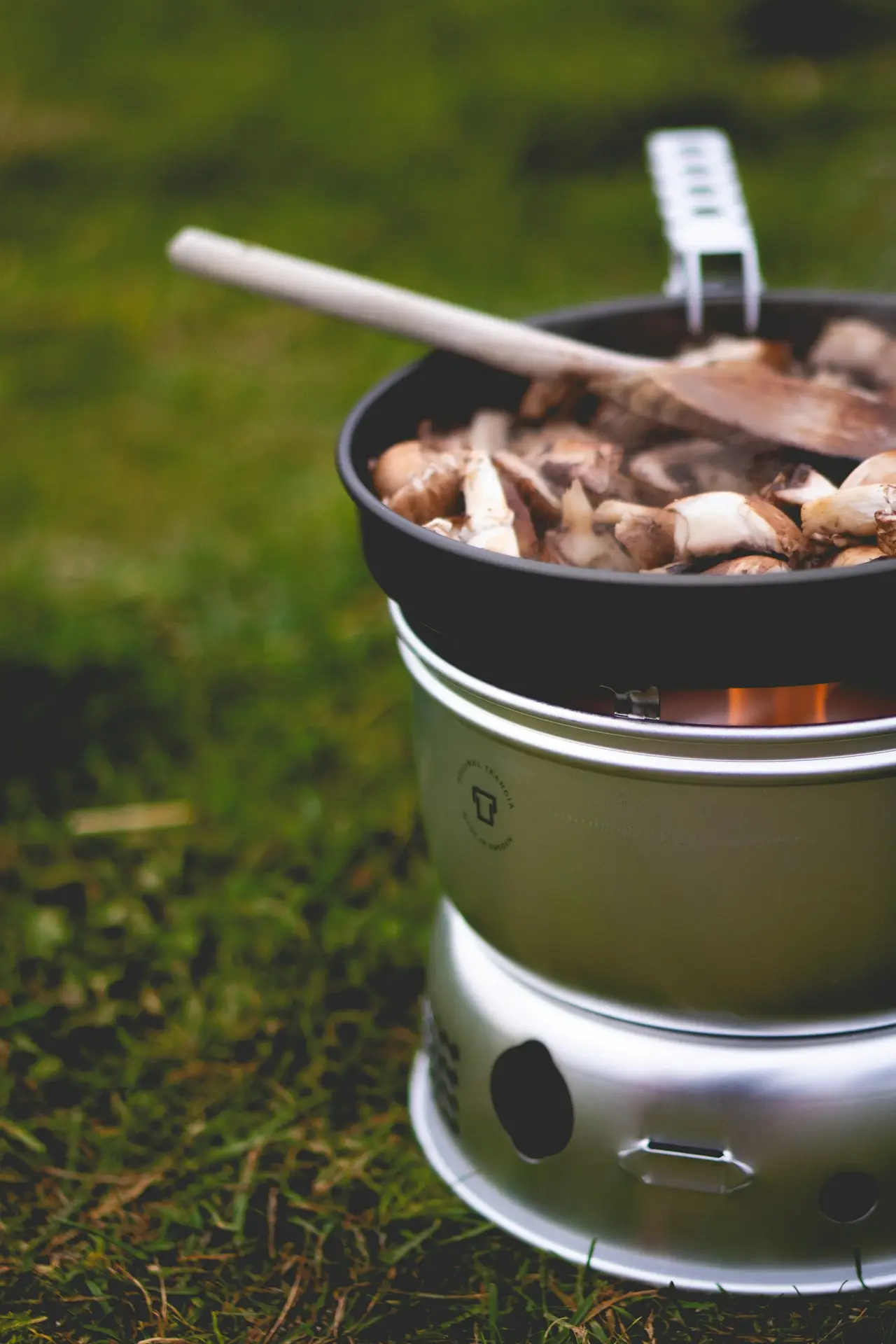A pot of food heating on a camp stove.