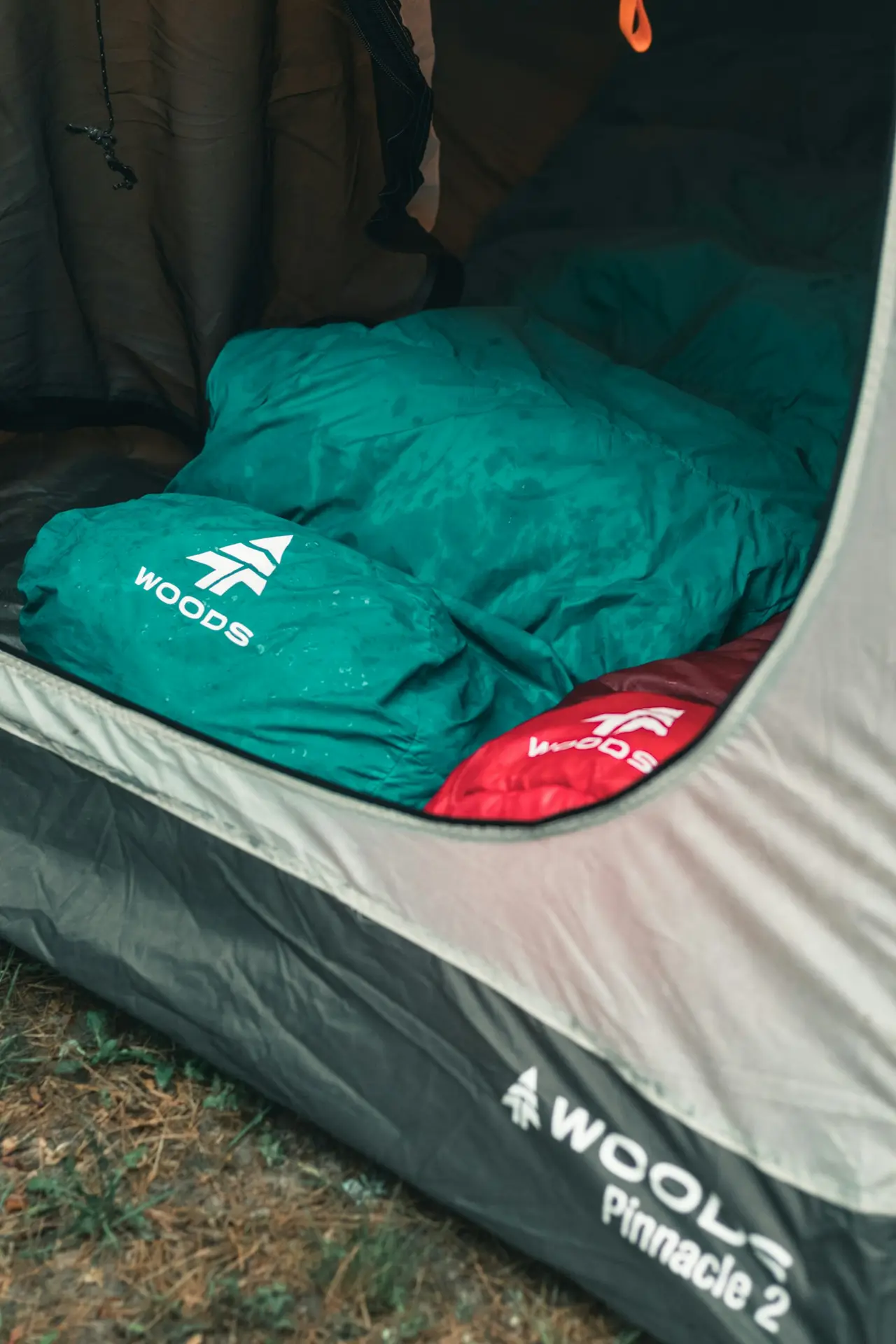 A sleeping bag laid out inside a pitched tent.
