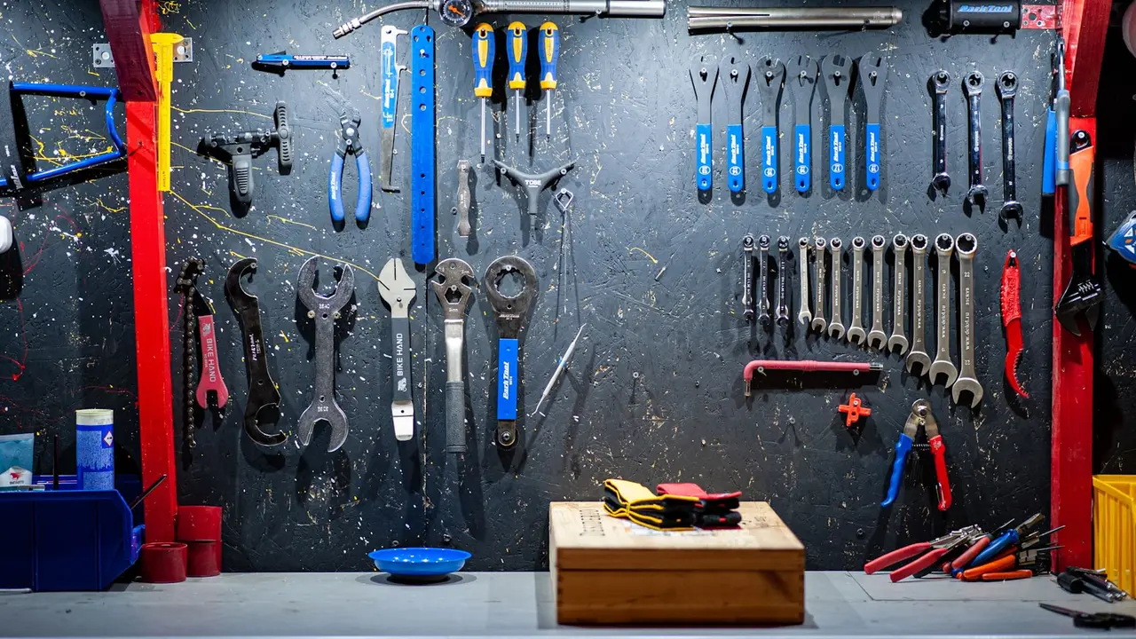 A workshop board hung with bicycle tools.